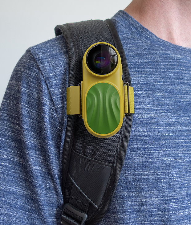 Owl device clipped to backpack strap
